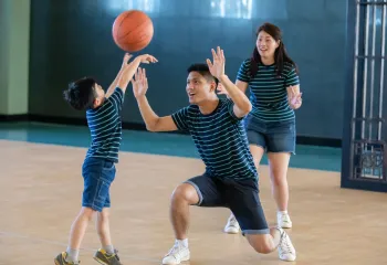 Family playing basketball