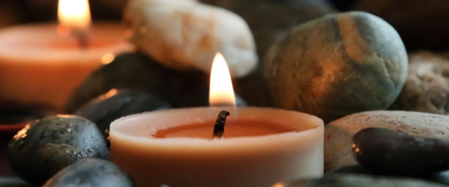 candle nestled in rocks