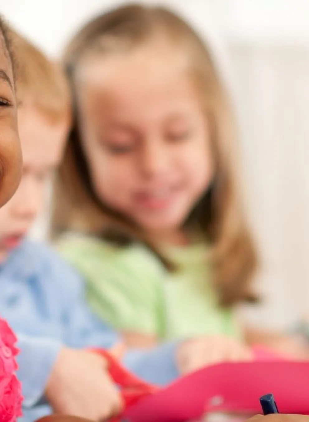 preschool children sitting at table coloring