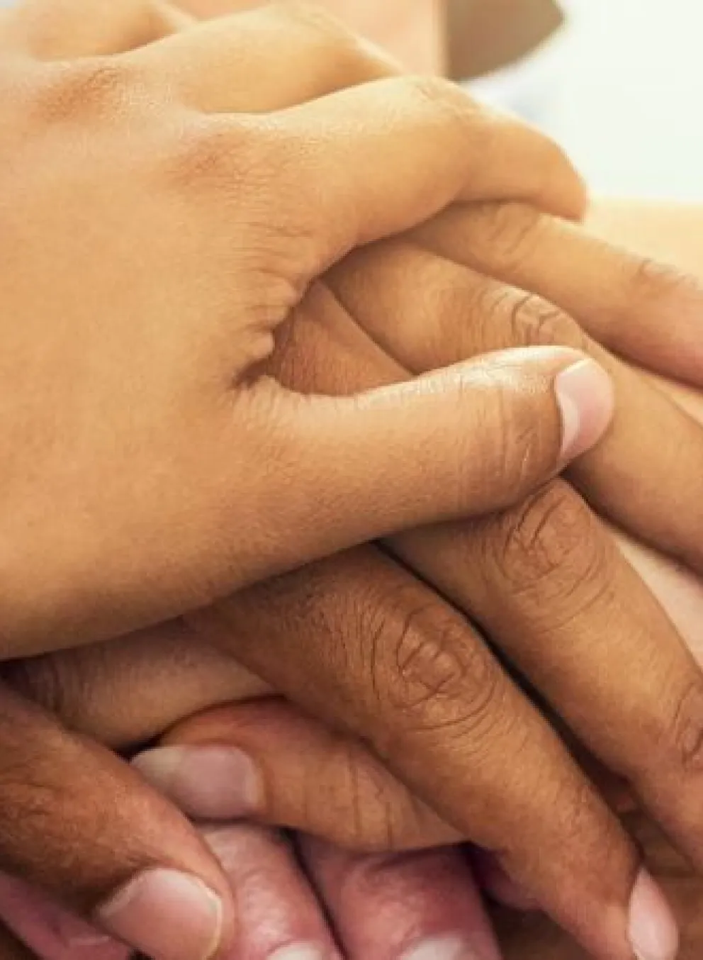 group of hands stacked on top of each other